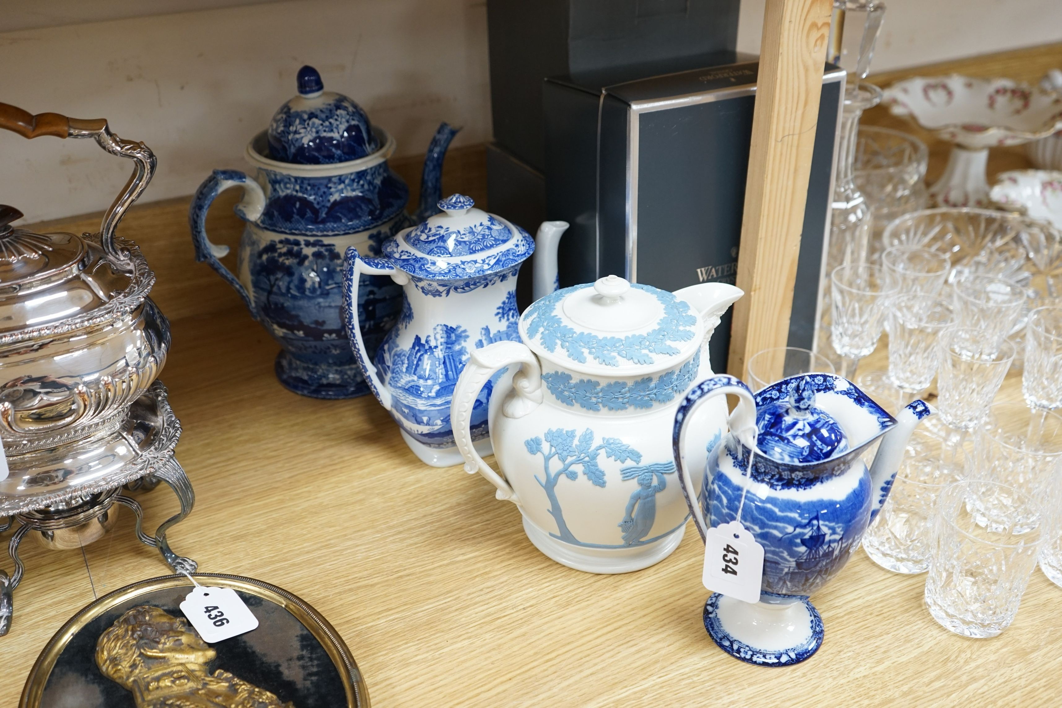 An early 19th century pearlware blue and white tea pot, two others and a Wedgwood style teapot, tallest 30cms high